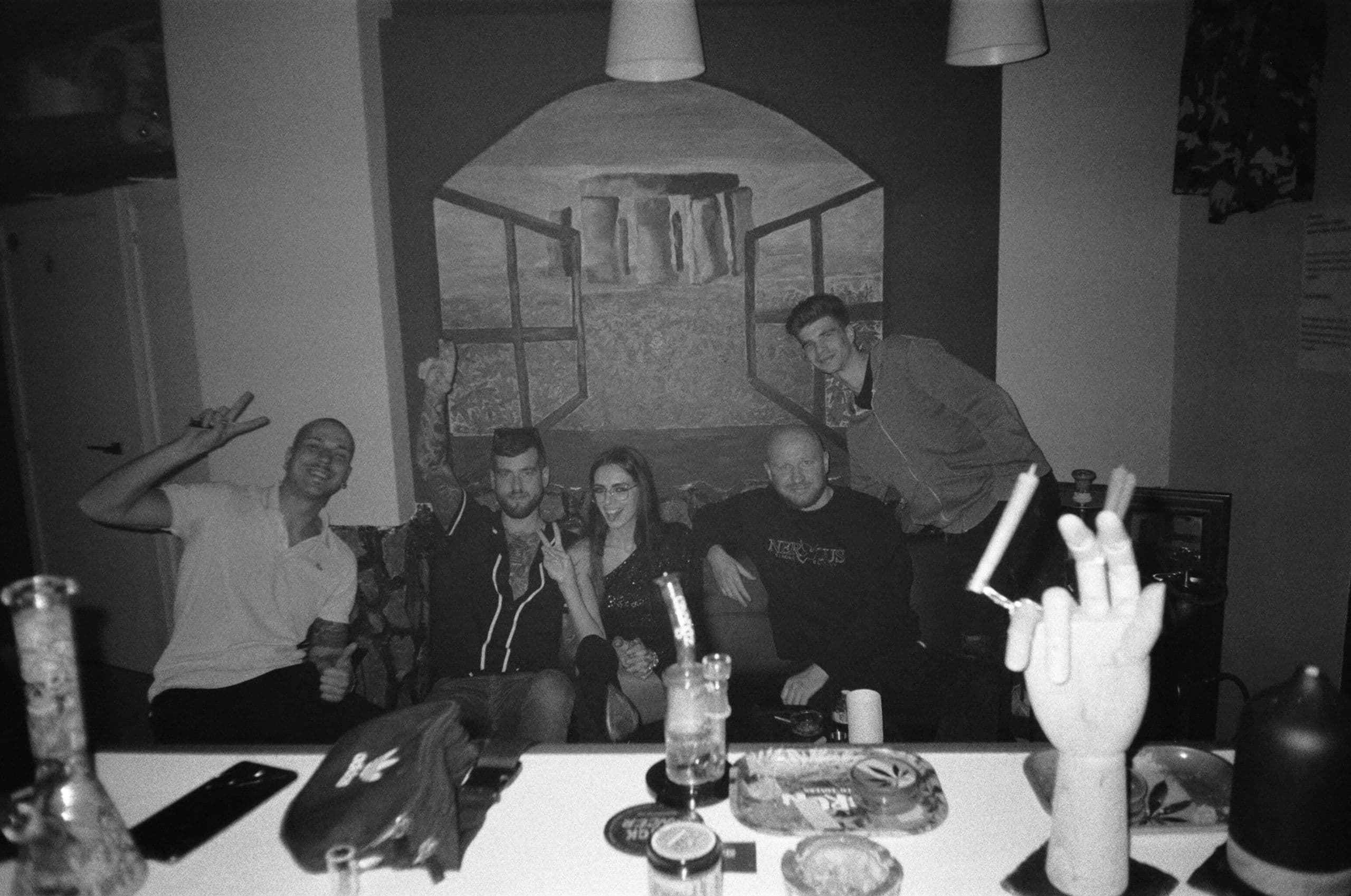 Members gathered on the lounge sofa beneath the Stonedhenge mural